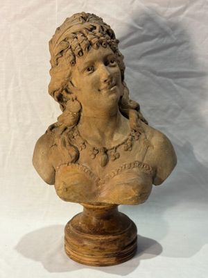 an image of a busturine of a woman on a wooden stand