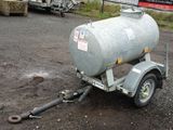 a trailer with a tank attached to it in a parking lot