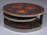 a picture of a three tiered coffee table with a design on it