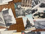many old postcards on the table with pictures of buildings