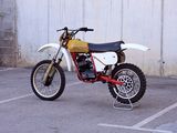 a dirt bike that is parked in a parking lot