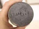 a person holding a stone with the word thank written on it