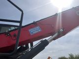 a red crane that is sitting on the back of a truck