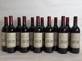 six bottles of wine are lined up on a table