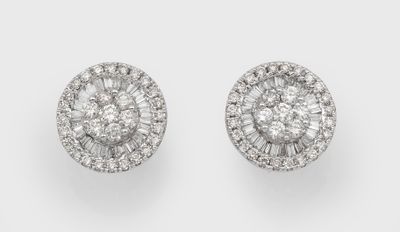 a pair of diamond and white gold earrings