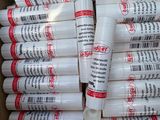 several tubes of glue sitting in a box on top of each other