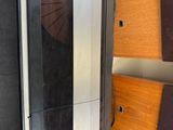 a metal and wood cabinet with a spiral door