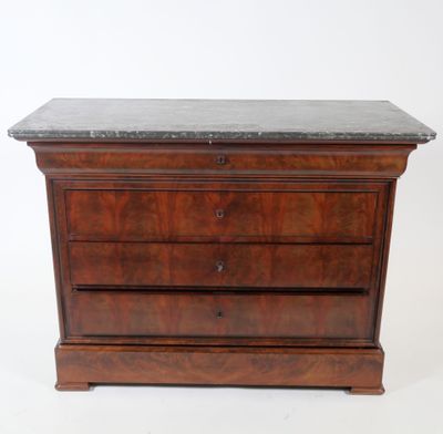 an old wooden chest of drawers with a marble top
