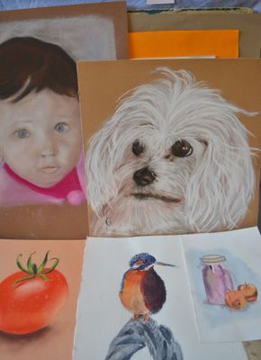 many pictures of a dog and a little girl on the table