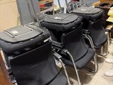 three black chairs in the room with luggage on them