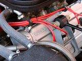 a close up of a car engine with wires attached to it