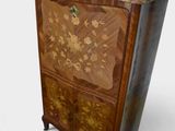 a small cabinet with a lamp on top of it