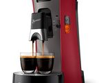 a close up of a coffee maker with two cups of coffee