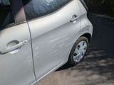a small car that is parked on the side of the road
