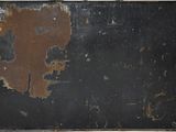 an old black suitcase with a rusted paint on it