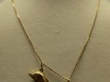 gold plated necklace with a coin and a bird charm