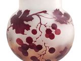 a glass vase with a red and white design on it