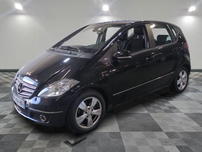a picture of a black mercedes b - class parked in a garage