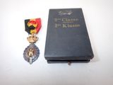an old book with a medal and a medal on top of it