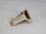 porcelain figurine of a trumpet shaped object on a white surface