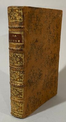 an old book sitting on top of a white table