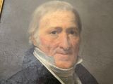 portrait of a man in a black coat and white collared shirt