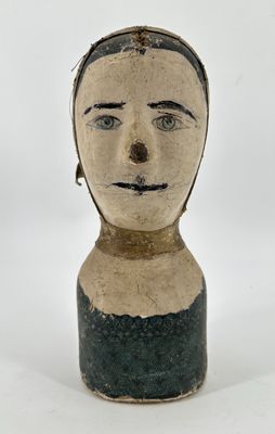 a clay head of a man with a black and white stripe on it