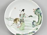 a plate with a woman and a dog on it