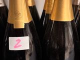 several bottles of champagne are lined up on a counter