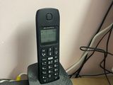 a cell phone sitting on top of a speaker on a table