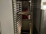 an image of a commercial kitchen with a rack full of pans