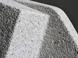 a close up view of a cement object with a black background