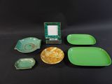 green and yellow dishes and a picture frame on a black table