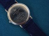 an image of a close up of a wrist watch on a blue surface