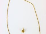 un collier en or orné d'une croix à l'avant et d'une petite croix à l'arrière