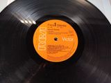 vinyl record sitting on top of a table with a label on it