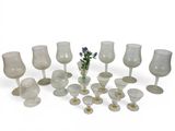 a lot of glasses and vases sitting on a table