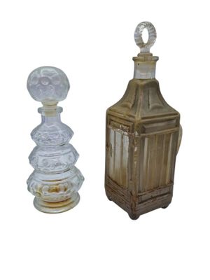 two glass bottles that are sitting next to each other