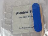 a package of alcohol pills and a toothbrush on a table
