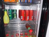 a refrigerator with drinks and juices inside of it