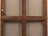 an old wooden frame with a window on the wall