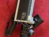 a video camera on a tripod on a red carpet