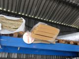 a blue conveyor belt with boxes on top of it