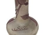 a glass vase with a horse on it on a white surface