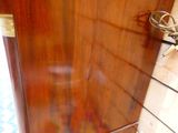 a wooden cabinet with a mirror on the top of it
