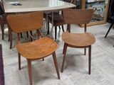 several chairs and a table in a room with a lot of furniture