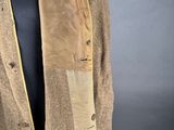 an old coat with a leather patch on the front and a leather patch on the back