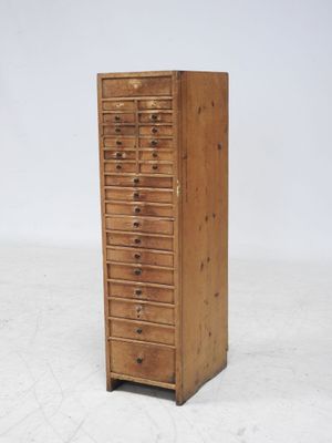 an image of a tall wooden cabinet with drawers and drawers
