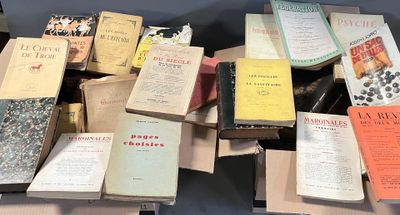 a lot of books on a table that are sitting on top of each other
