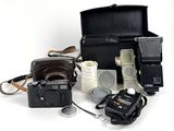 a black case with a camera, a camera, and other items on it